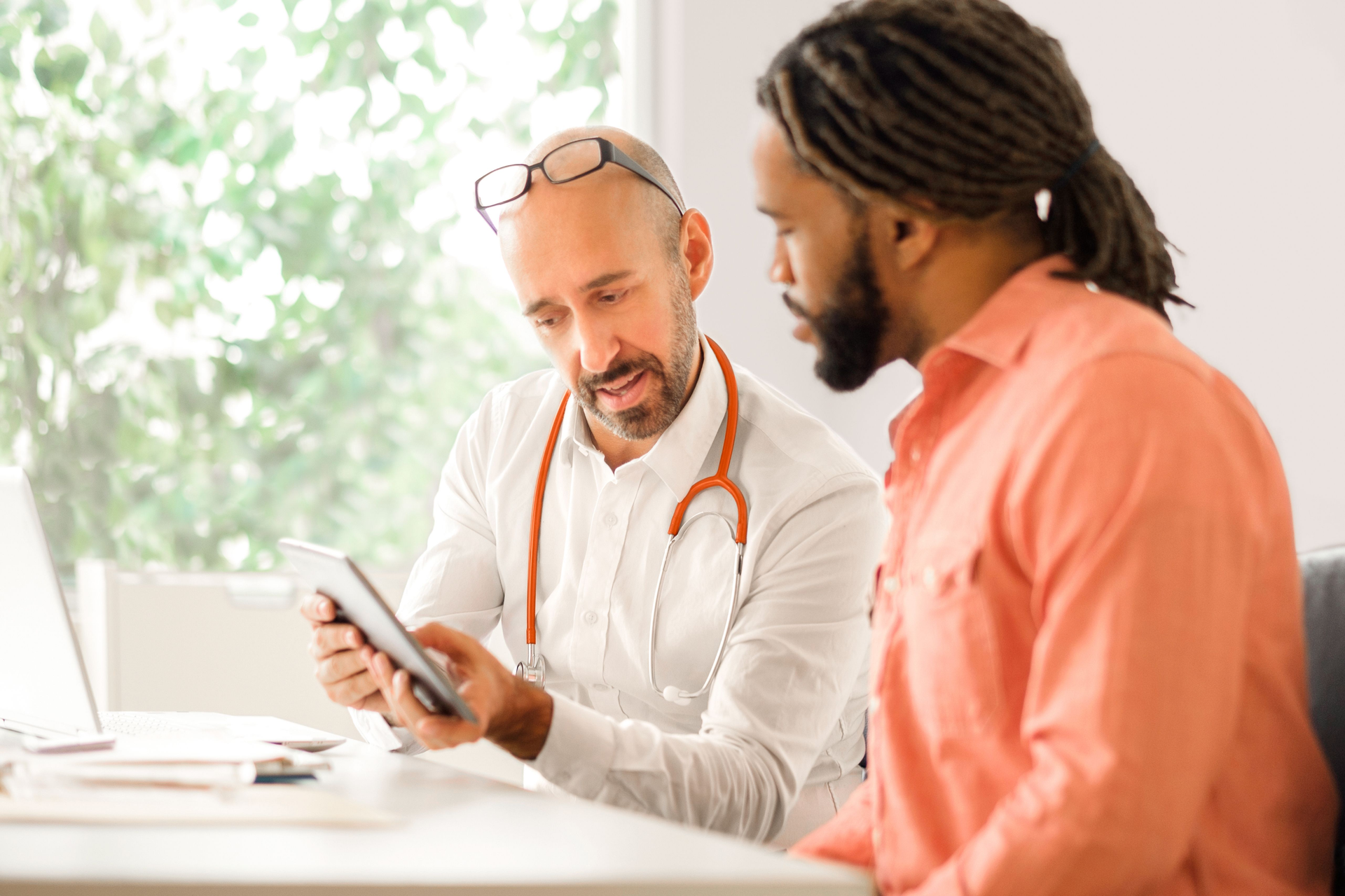 Doctor explaining medical information to a patient, demonstrating care and communication